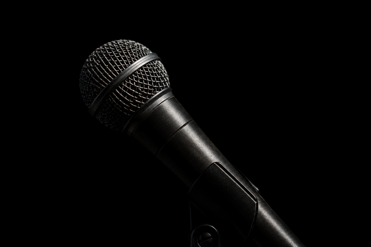 A microphone shot against black — the freestyle happens once, with no second take.