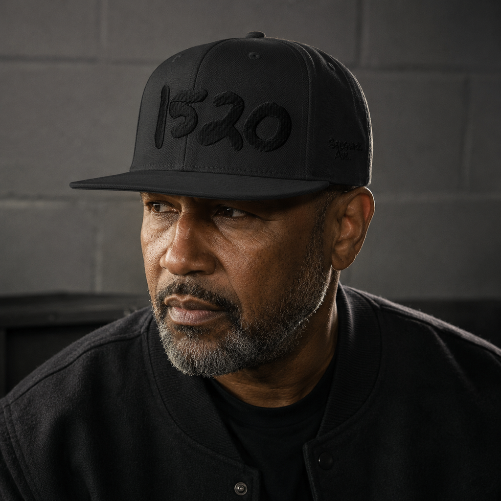 Man in black wearing the black-on-black 1520 Cap indoors