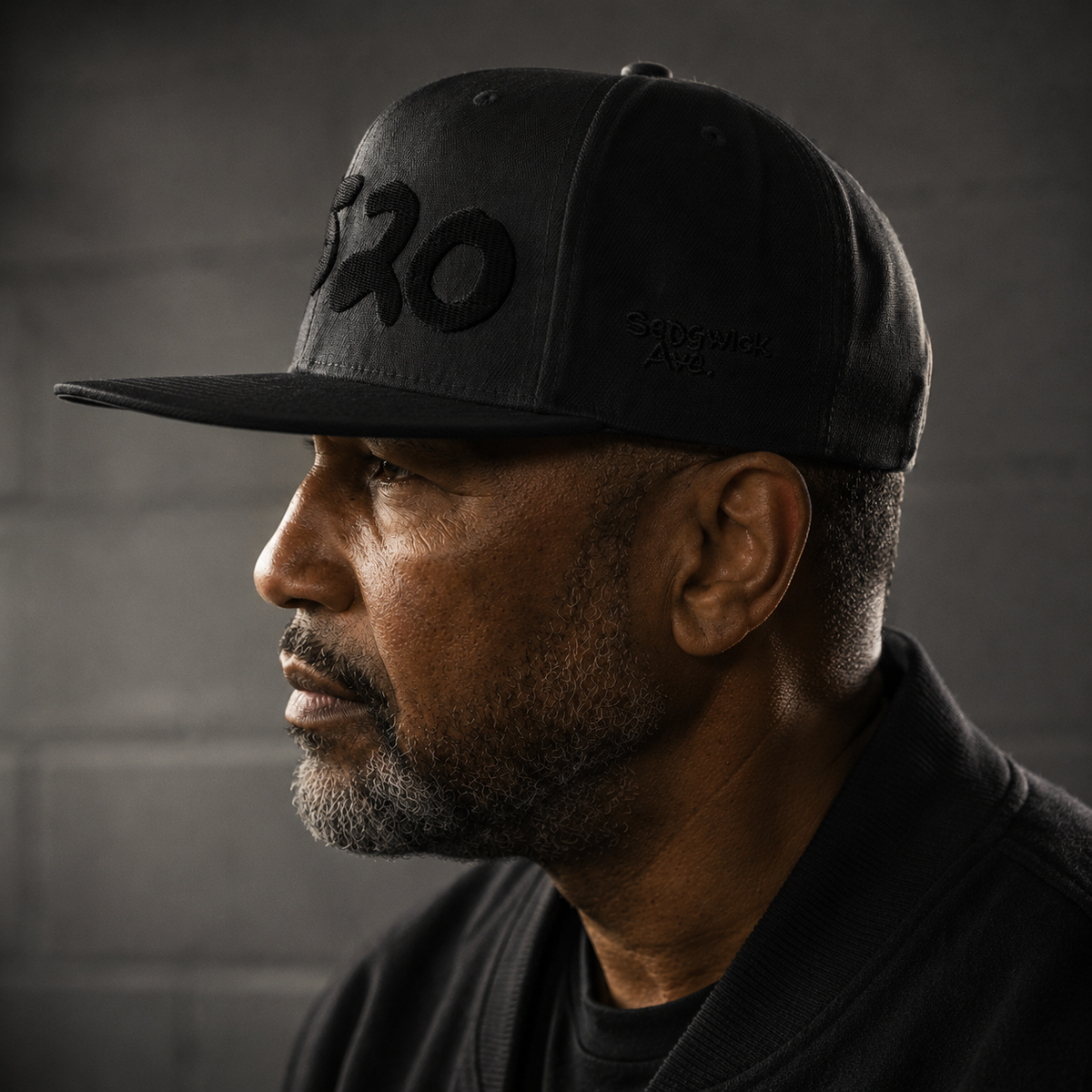 Side profile of a man wearing the black 1520 Cap